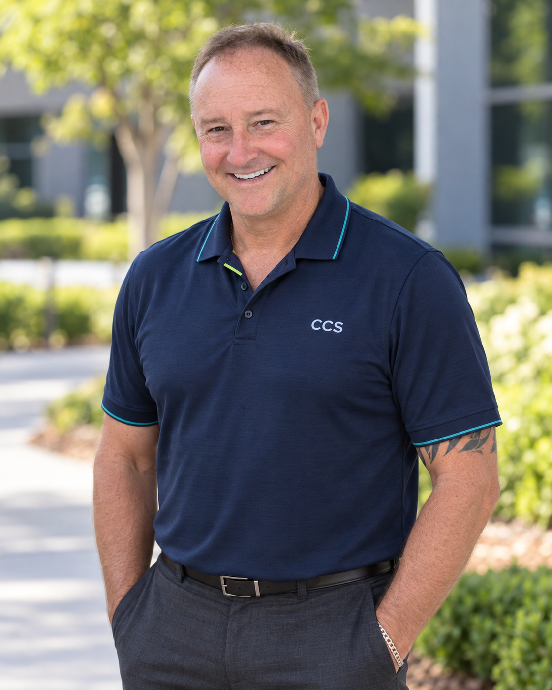 Shaun, founder of CCS, standing outdoors in a navy company polo.